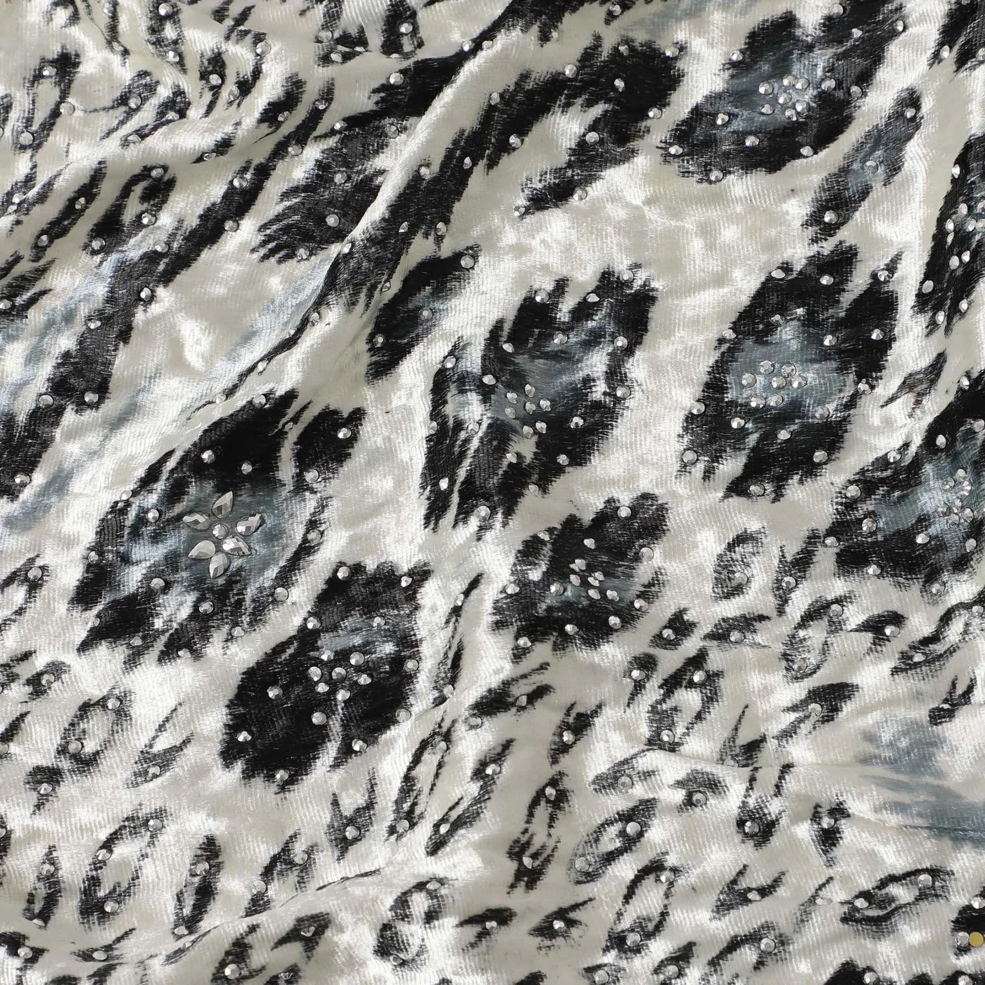 Daisy white Rayon velvet fabric with black, pewter grey print having metallic silver studs in abstract design